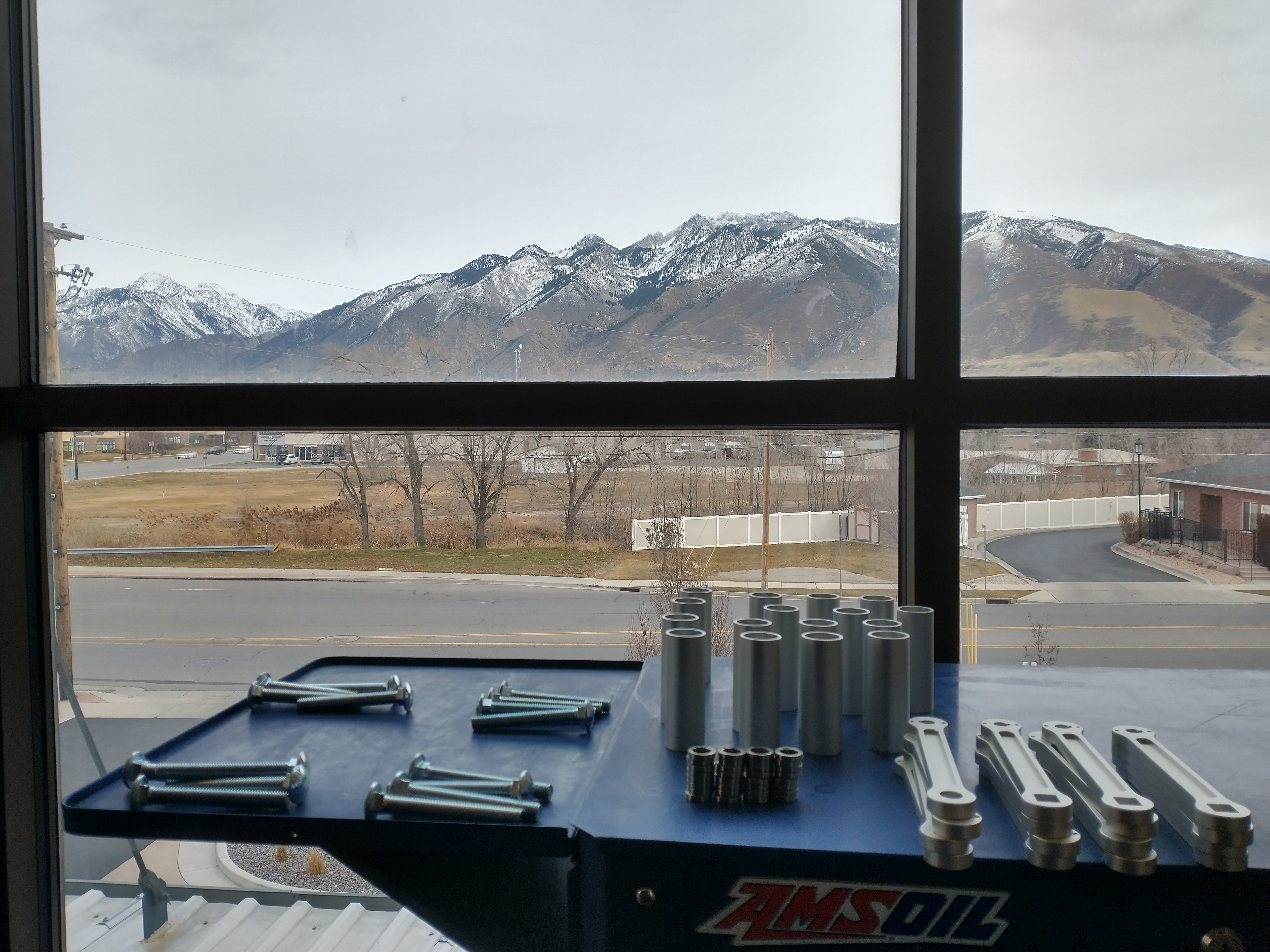 Zeus Dynamo Powerhouse components being hand-assembled in our workshop, with the Wasatch Mountains in the background.