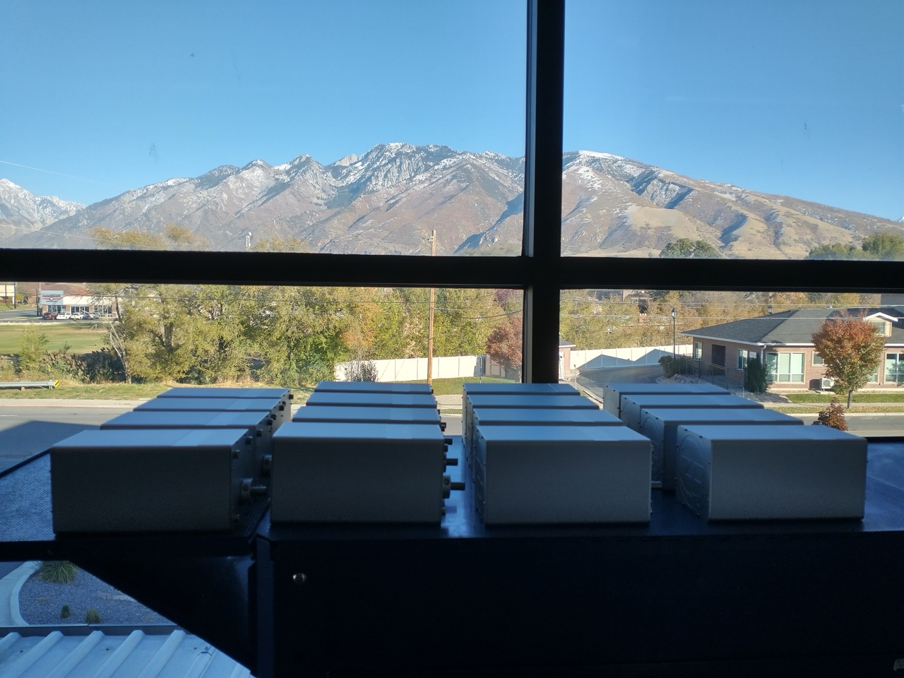 Zeus Dynamo hand crank generators on a workshop bench with the Rocky Mountains in the background.